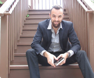 Narrator Tim Campbell sitting on staircase